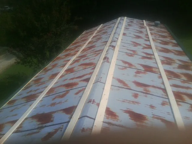 Rusted metal roof panels with new wood purlins before replacement — Storm Damage Roof Repair in Royse City by Roofing Brothers