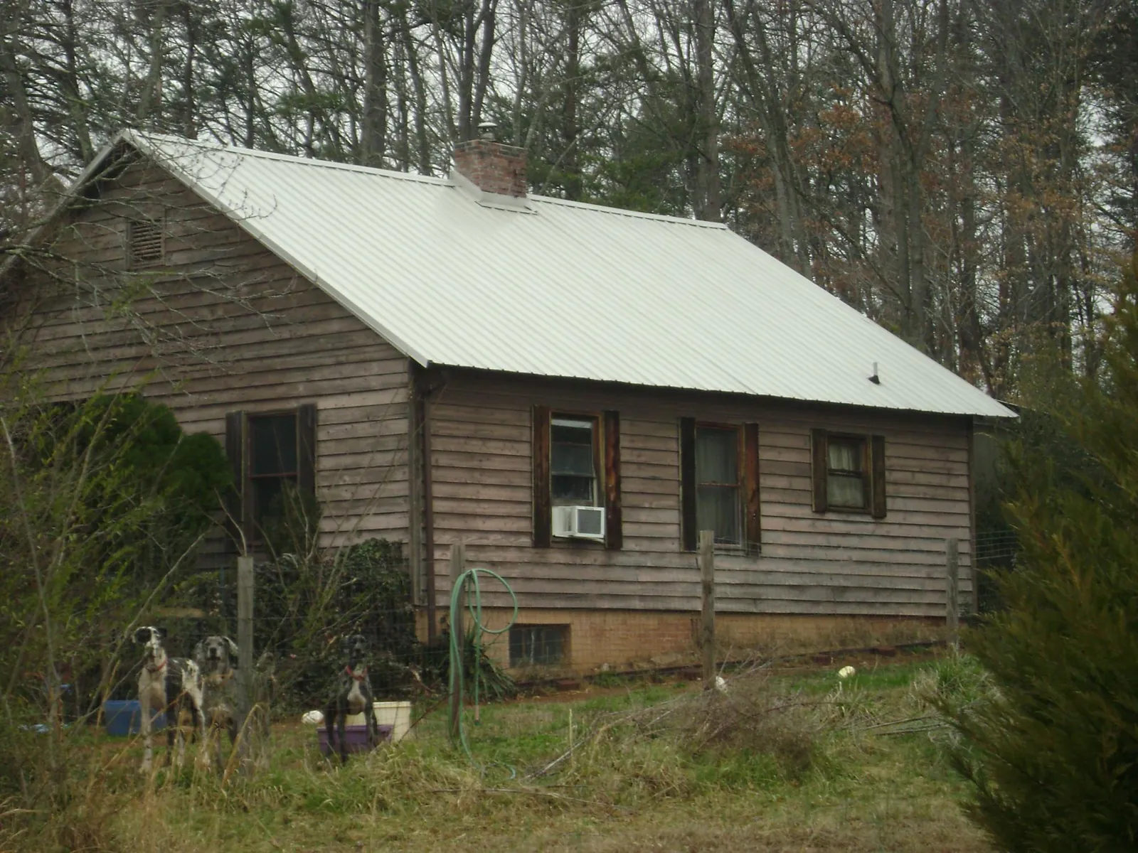 White metal roof on an old wood sided farmhouse, from a Metal Roof Installation job in Royse City